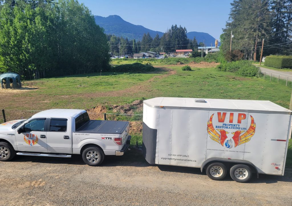 VIP Property Restoration truck and trailer with Cowichan Valley mountain backdrop